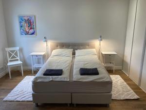 a bed with two pillows on it in a bedroom at Lossi Apartment in Kuressaare