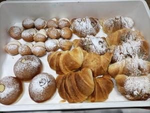 a tray filled with pastries and other pastries at B&B Stella Maris Trapani Centro in Trapani