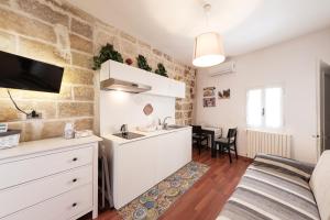 a kitchen and living room in a apartment at Casa Chiasso Cacace in Monopoli +37 photos