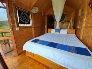 a bedroom with a large bed in a boat at Little Mai Chau Home Stay in Mai Châu