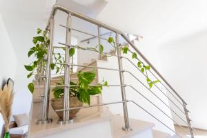 a metal stair railing with a plant in a pot at Villa Mamma Grazia Rooms in San Vito dei Normanni