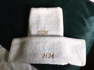 two towels with numbers on them on a bed at Hotel Margaritar in Buşteni
