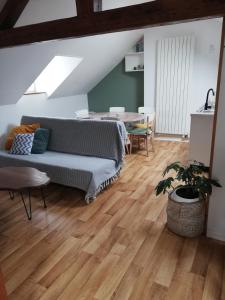 a living room with a couch and a table at La Plage in Fécamp