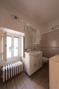 a bathroom with a sink and a toilet and a window at Casa Chiasso Cacace in Monopoli +35 photos