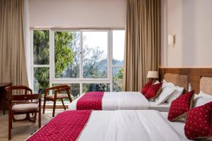 Postel nebo postele na pokoji v ubytování THRILL HOLIDAYS MUNNAR