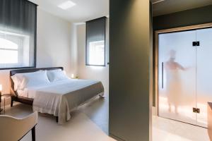 A bed or beds in a room at Byssus Suites