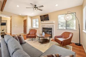 a living room with a couch and chairs and a fireplace at Blue Cocoon in Cambria