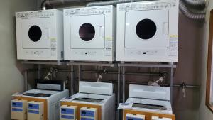 a group of microwaves and appliances on a shelf at Nobeoka Urban Hotel in Nobeoka +15 photos
