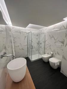 a white bathroom with a toilet and a sink at Room Verona Ai Conti in Verona