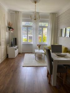 a living room with a table and a dining room at Villarheinblick in Kamp-Bornhofen