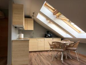 a kitchen with a dining table and a skylight at Precioso apartamento con vistas al mar en Carnota in Carnota