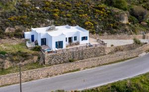 a house on a hill next to a road at Sacada Seascape Nisyros in Páloi