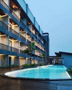 a large swimming pool in front of a building at Grand Miami Hotel in Malang