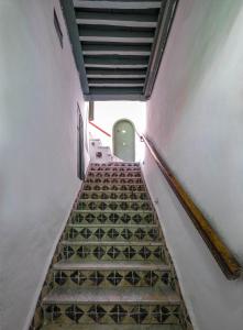 a staircase leading up to a green door at Dar Hayder-la Medina in Tunis