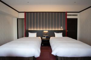 Postel nebo postele na pokoji v ubytování Kobe Seishin Oriental Hotel