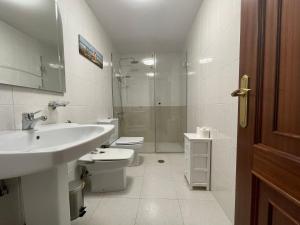 a bathroom with a sink and a toilet and a shower at Oktheway Rua Nova 3D in Sarria +18 photos