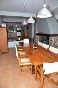 a dining room with a wooden table and chairs at VILA AMALIA in Theológos
