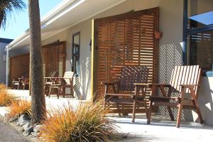 a group of chairs and tables on a patio at New Plymouth TOP 10 Holiday Park in New Plymouth