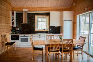 a kitchen with a wooden table and chairs at Kåvanstugan Funäsdalen in Funäsdalen