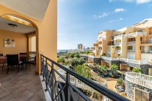 a balcony with a view of the city at Tropical Holiday Apartment in Los Cristianos