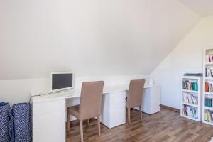 a desk with two chairs and a computer on it at Villa Bel Air in Criel-sur-Mer
