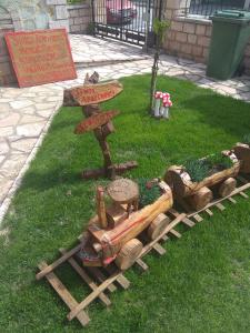 a wooden train on the grass next to a table at Simos Apartments in Korinos