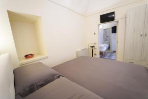 Un pat sau paturi într-o cameră la Santa Cesarea Residence Casa Vacanze