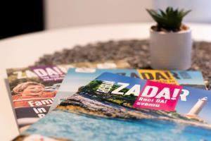 a table with magazines on top of a table at Sunset Apartment in Zadar