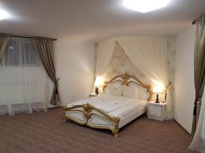 a bedroom with a large white bed with two lamps at Wall St House in Sibiu