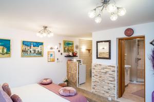 a bedroom with a bed and a bathroom at Apartments Plaza in Dubrovnik