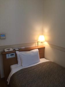 Cama o camas de una habitación en Hotel Sunroute Patio Omori