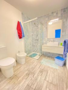 a bathroom with a toilet and a shower and a sink at Penthouse "Maltese scent" in Mellieħa