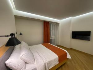 Ένα ή περισσότερα κρεβάτια σε δωμάτιο στο MIST Boutique Hotel