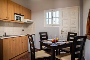 a kitchen with a table and chairs in a kitchen at Blue Sky in Sidari