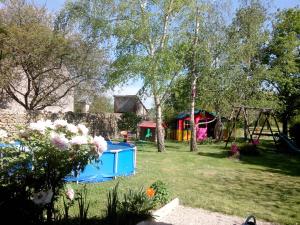 a yard with a playground and a swing set at LES HIRONDELLES in Onzain