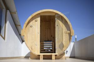 a wooden door with a staircase in a building at Guest House Adriatica by Pinch in Pakoštane