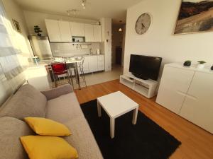 a living room with a couch and a table and a kitchen at Beata East Side apartment in Split