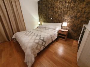 a bedroom with a bed and a side table with a lamp at Beata East Side apartment in Split