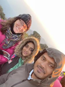 a group of three people posing for a picture at Langdak Homestay in Darjeeling