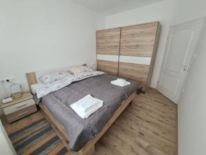 a bedroom with a large bed and a wooden floor at Šimun in Karlovac