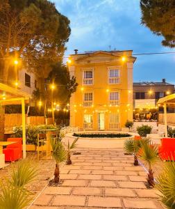 un edificio amarillo con un patio delante de él en Hotel Venteo, en Platja d'Aro