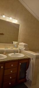 a bathroom with two sinks and a large mirror at Casa Belo Horizonte in Lourinhã +20 photos