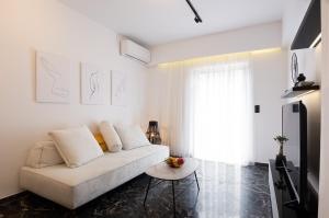 Biały salon z białą kanapą i stołem w obiekcie Lux apt next to port & city center w Heraklionie