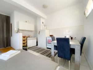 a kitchen with a table and chairs in a room at Apartmani Milan in Trebinje