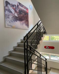 a staircase in a house with a painting on the wall at Hotel Aurora & Appartamenti in Nago-Torbole