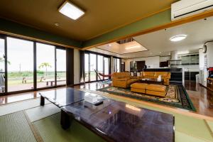 uma sala de estar com um sofá e uma mesa em Comfort House In Miyakojima em Ilhas Miyako