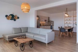 a living room with a couch and a table at Panteronisia View Villa in Angairiá
