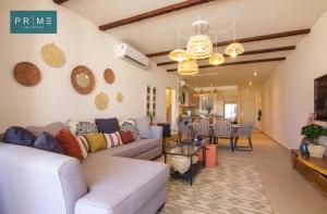 a living room with a couch and a table at Prime Holidays Seashell in El Alamein