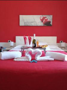 a red bedroom with a bed with two swans on it at AD Trastevere Guest House in Rome