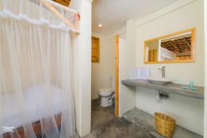 a bathroom with a sink and a toilet at Casa de la Gente Nube in Puerto Escondido +195 photos